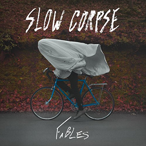 "Album cover with person on a blue bike covered by a white sheet."