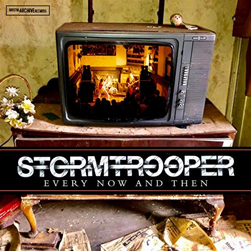 "Album cover with old TV on cluttered table, showing a room scene."