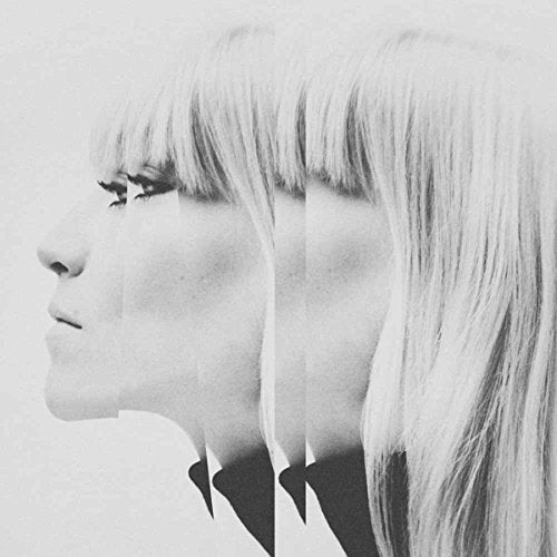 A black and white image of a woman's face, distorted with multiple overlapping profiles.