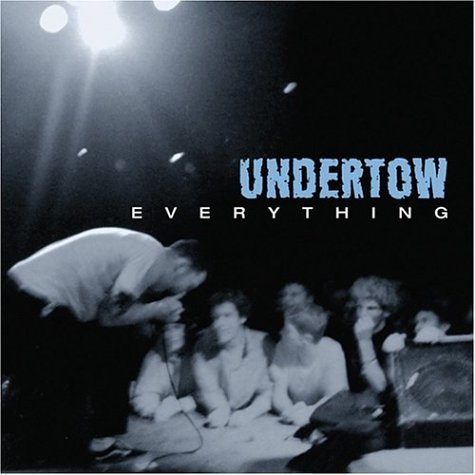 "Undertow album cover, black and white image of band performing on stage."