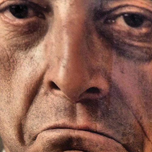 A close-up of a man's face, showing his eyes, nose, and mouth.