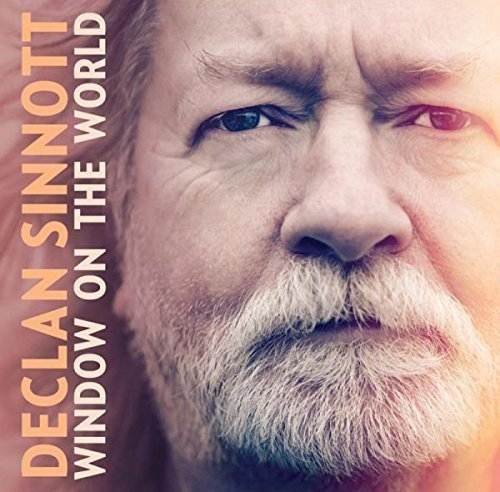 "Album cover with a close-up of a man's face and orange text."
