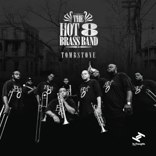 "Album cover featuring a black-and-white image of a brass band holding instruments."