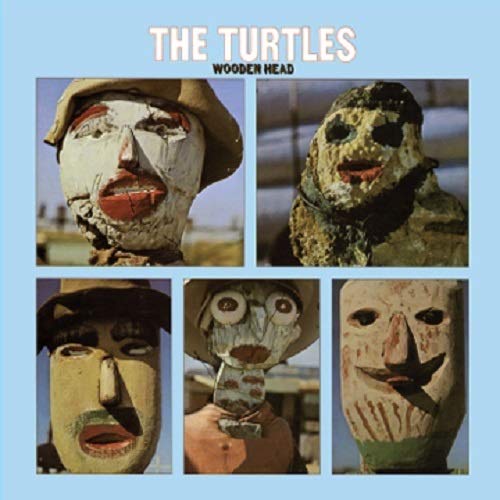 "Album cover with 'The Turtles' and 'Wooden Head' text, featuring five wooden masks."