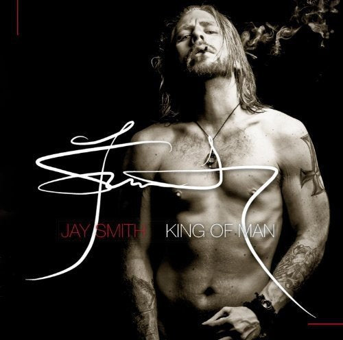 "Album cover featuring shirtless man with tattoos and long hair against a black background."
