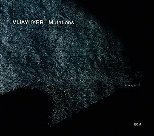 The alt text for the image is: "Album cover for 'Vijay Iyer - Mutations' with dark textured background."