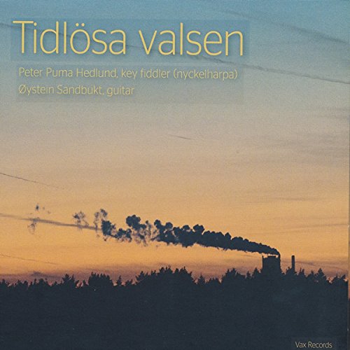 "CD cover with a forest and smokestack at sunset, yellow text at the top."