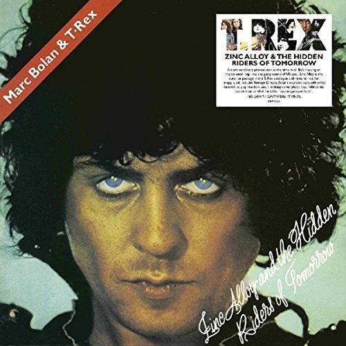"Album cover featuring a close-up of a man's face with blue eyes and dark hair."