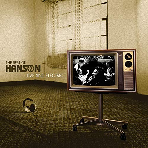 "Vintage television on stand shows black-and-white image of musicians, with headphones on the floor."