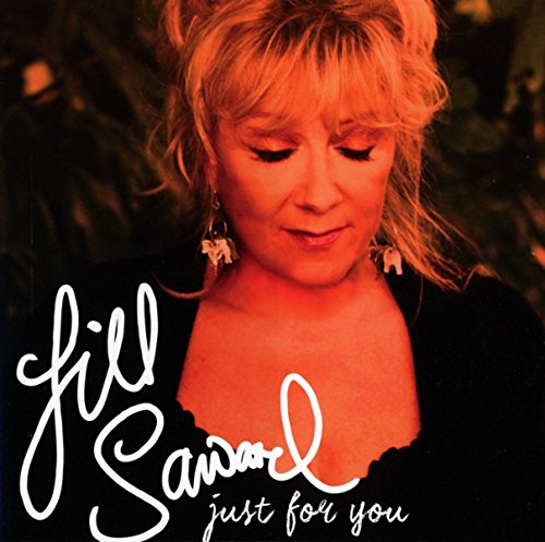 "Album cover with a woman in a black top and floral earrings."