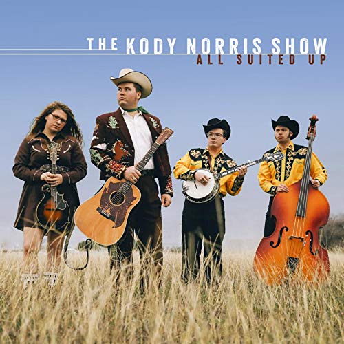 "Album cover featuring four musicians in cowboy attire standing in a field with instruments."