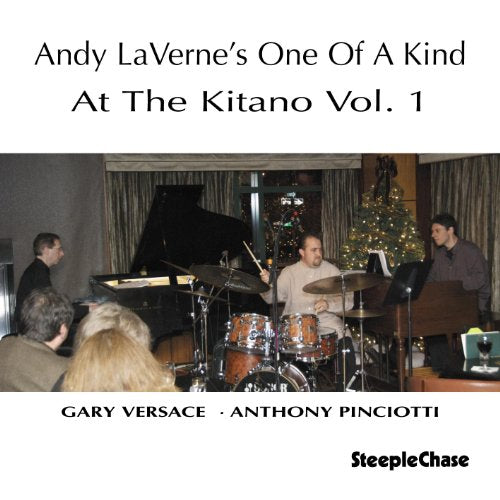 "CD cover featuring a jazz trio performing on stage with a Christmas tree."