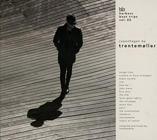 "Album cover with man in dark clothing on wooden dock, text on beige right side."
