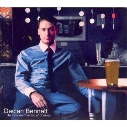 Album cover: man in blue shirt sits at table with a glass of beer.