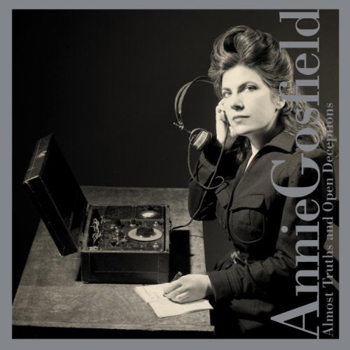 Black-and-white album cover featuring a woman using a vintage recording device on a desk.
