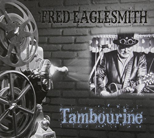 Black and white album cover featuring a man playing guitar, with a film projector.