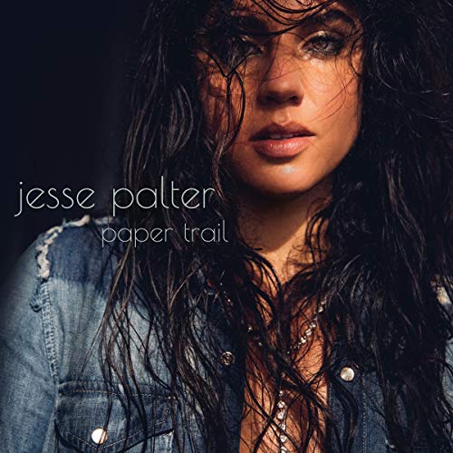 "Album cover featuring a woman with long dark hair and a denim jacket."
