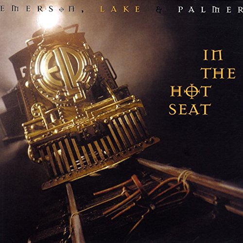 "Album cover featuring a golden train engine with 'In the Hot Seat' text."