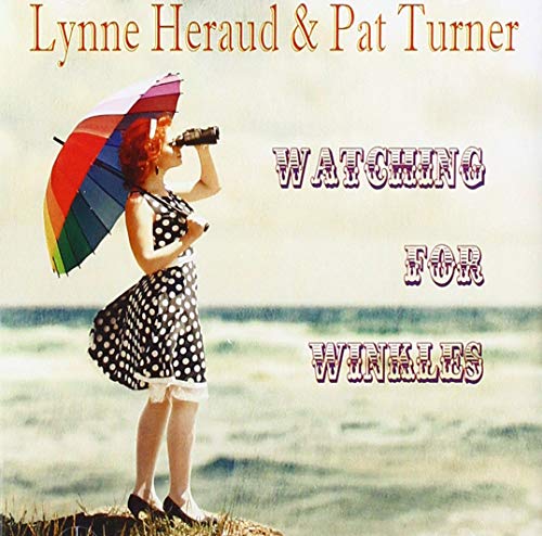 "Album cover featuring a woman with red hair holding binoculars and a rainbow umbrella."