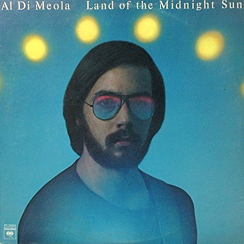 Album cover featuring Al Di Meola with dark hair, sunglasses, and a blue background.