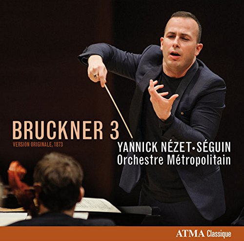 Conductor in a dark suit holding a baton, leading an orchestra on a CD cover.