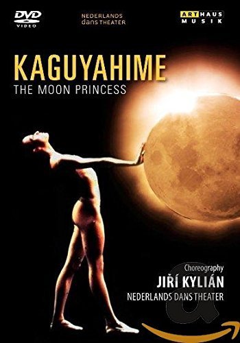Dancer in a ballet pose reaching for a glowing moon on a black background.