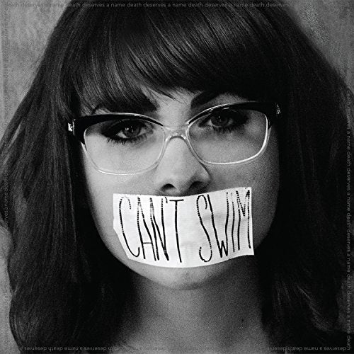 Black and white album cover with a woman's face and tape over her mouth.