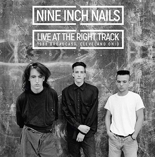 Black and white vinyl album cover featuring three men standing against a marbled background.