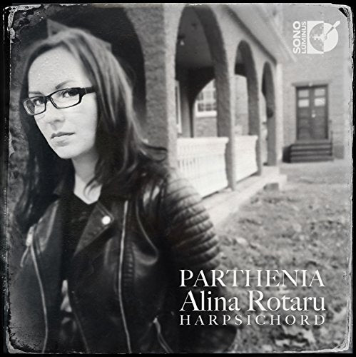 Black and white album cover featuring a woman standing outside a building.