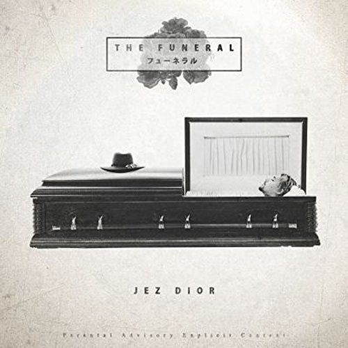 "Album cover featuring a black coffin with a hat and a man's head inside."
