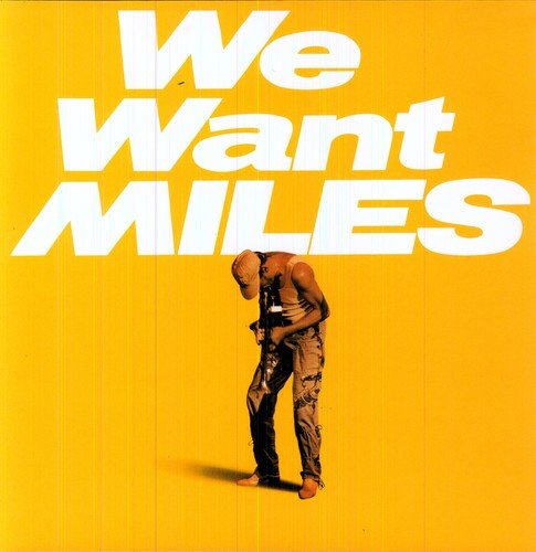 "Album cover with man holding trumpet on yellow background, text 'We Want Miles'."