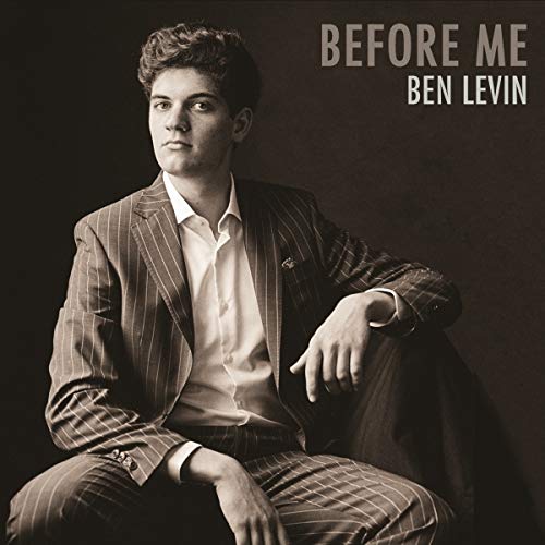 "Black and white album cover featuring a man in a pinstriped suit."
