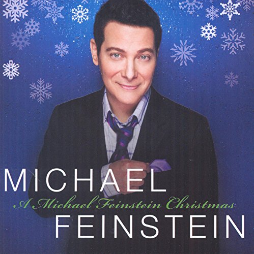 "Michael Feinstein's Christmas album cover featuring him in a suit against a snowy blue background."