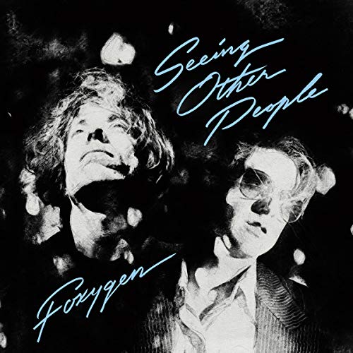 "Album cover with black and white photo of two men and blue text."
