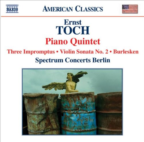 "CD cover with a statue of a winged figure on rusty barrels."
