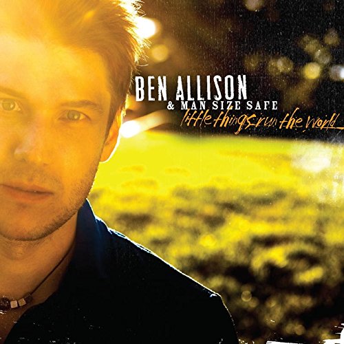 Album cover featuring a man with short hair and a necklace, outdoors at sunset.