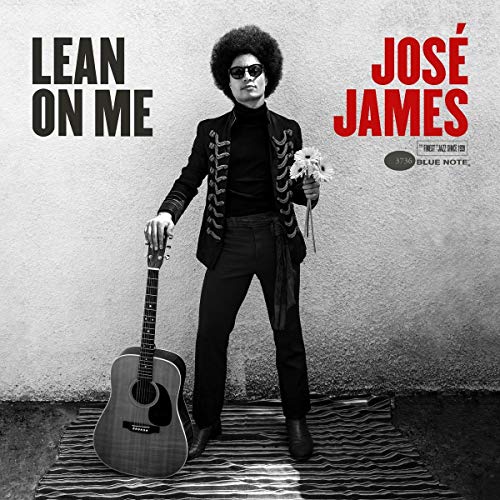 Album cover featuring José James holding a guitar and flowers, wearing dark attire.