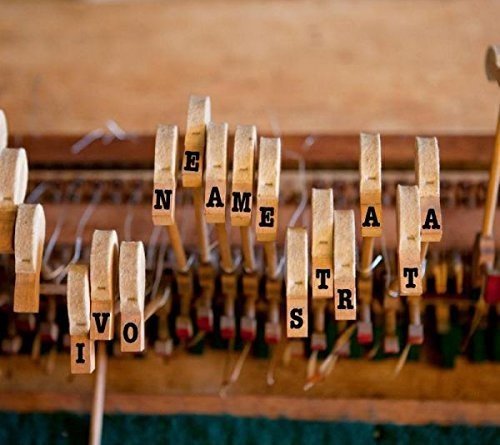 Piano keys with clothespins holding letters spelling "IVO NEAME STRATA" on wooden clothespins.