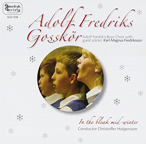 "CD cover with three boys singing, surrounded by snowflakes, on a white background."