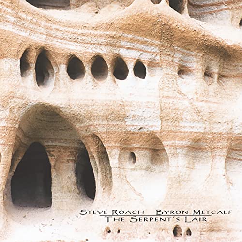 Textured sandstone rock formation with small caves and text reading The Serpent's Lair.