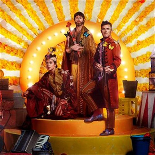 "CD cover art featuring three men in ornate costumes posing on a stage."