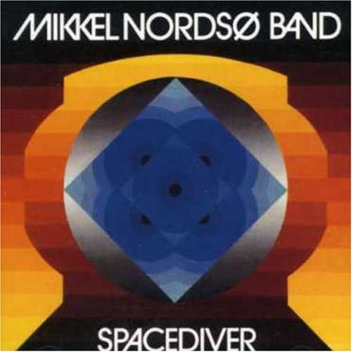 The alt text for the image is: "Album cover with geometric shapes and orange, blue, and black colors."