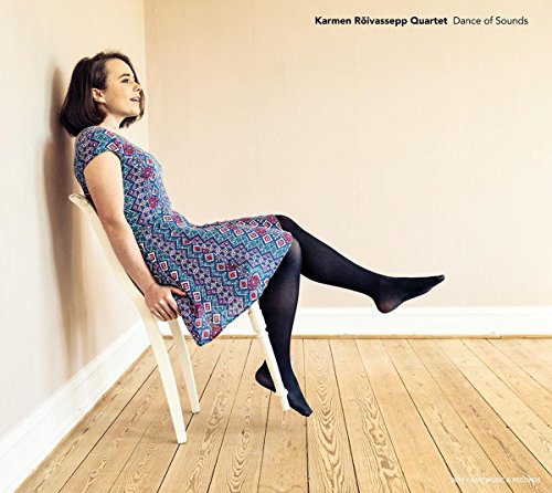 "CD cover featuring a woman sitting on a chair, leaning against a wall."