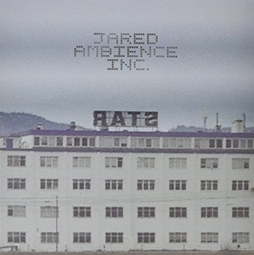 "Album cover featuring a faded, white, multi-story building with 'STAR' sign on roof."
