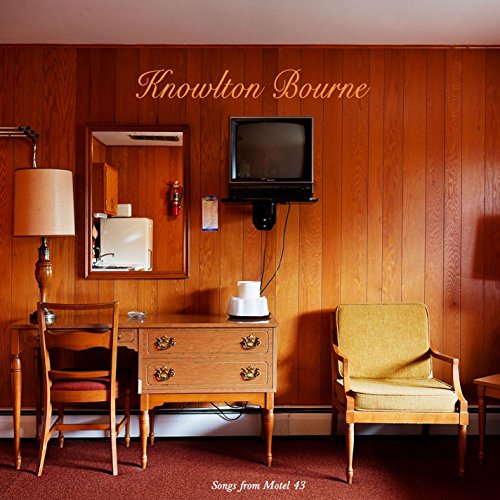 "Album cover featuring a retro motel room with wood paneling and vintage furniture."