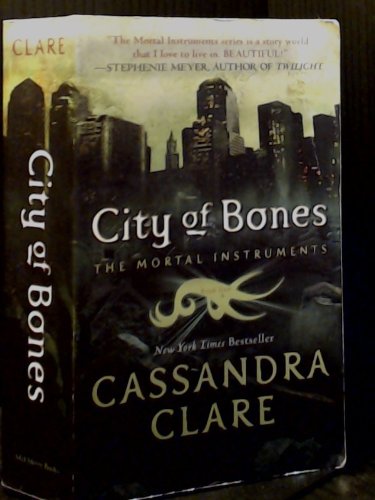 "Book cover of 'City of Bones' by Cassandra Clare, featuring a kneeling person with a sword."