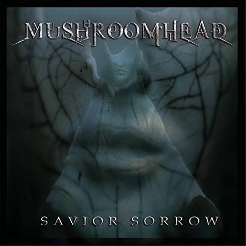Mushroomhead album cover featuring a stone statue with horns and spider web background.