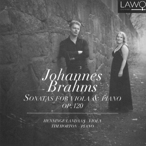 Black and white CD cover featuring a man and woman standing by a stone wall.
