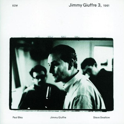 Black and white album cover with a photograph of three men.