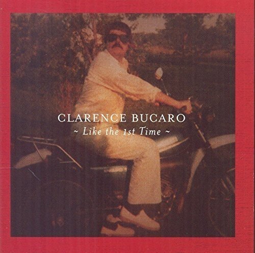 CD cover with man in white outfit on motorcycle, red border.